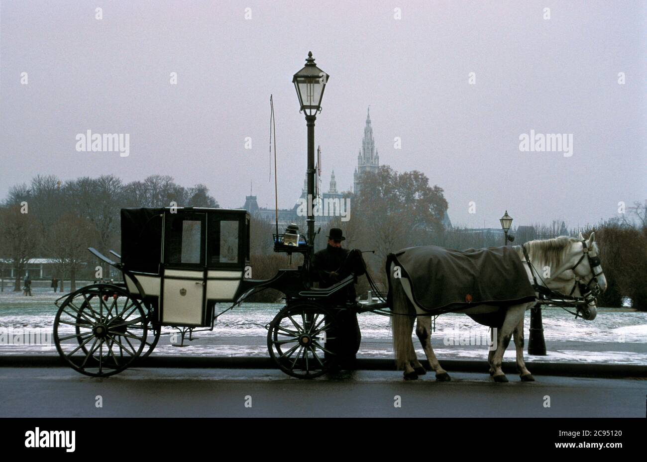 A fiacre driver awaits customers on a winter day outside the Hofburg Palace in Vienna, Austria Stock Photo