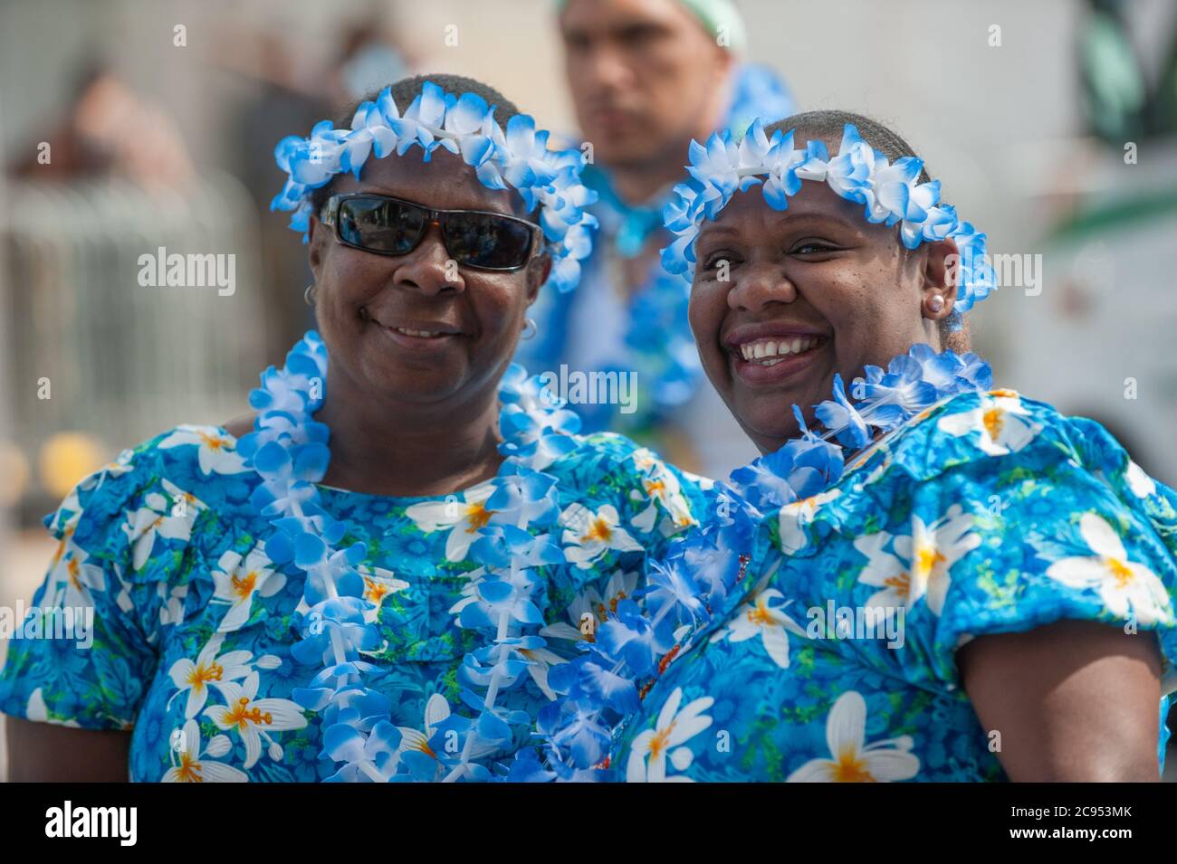 Two smiling Torres Strait island females in colourful costumes enjoy the atmosphere of the cultural festival in Cairns, Queensland, Australia. Stock Photo