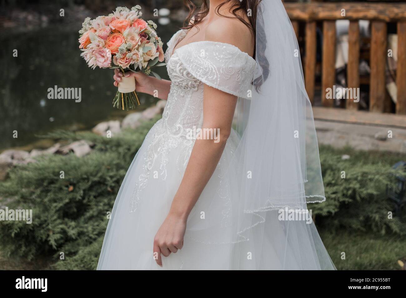 bride in wedding dress and with a bouquet Stock Photo - Alamy
