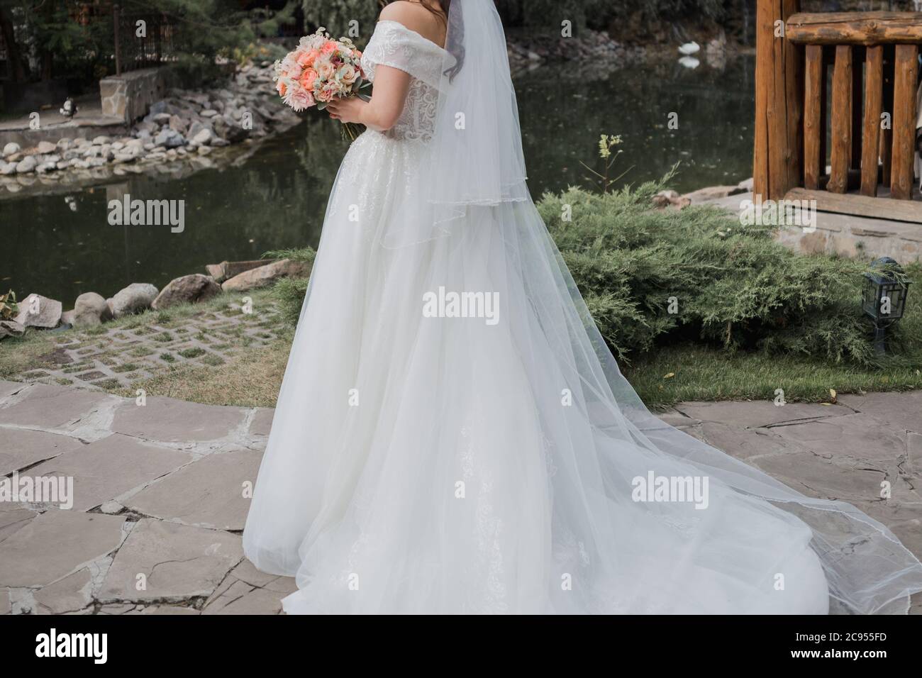 bride in wedding dress and with a bouquet Stock Photo - Alamy