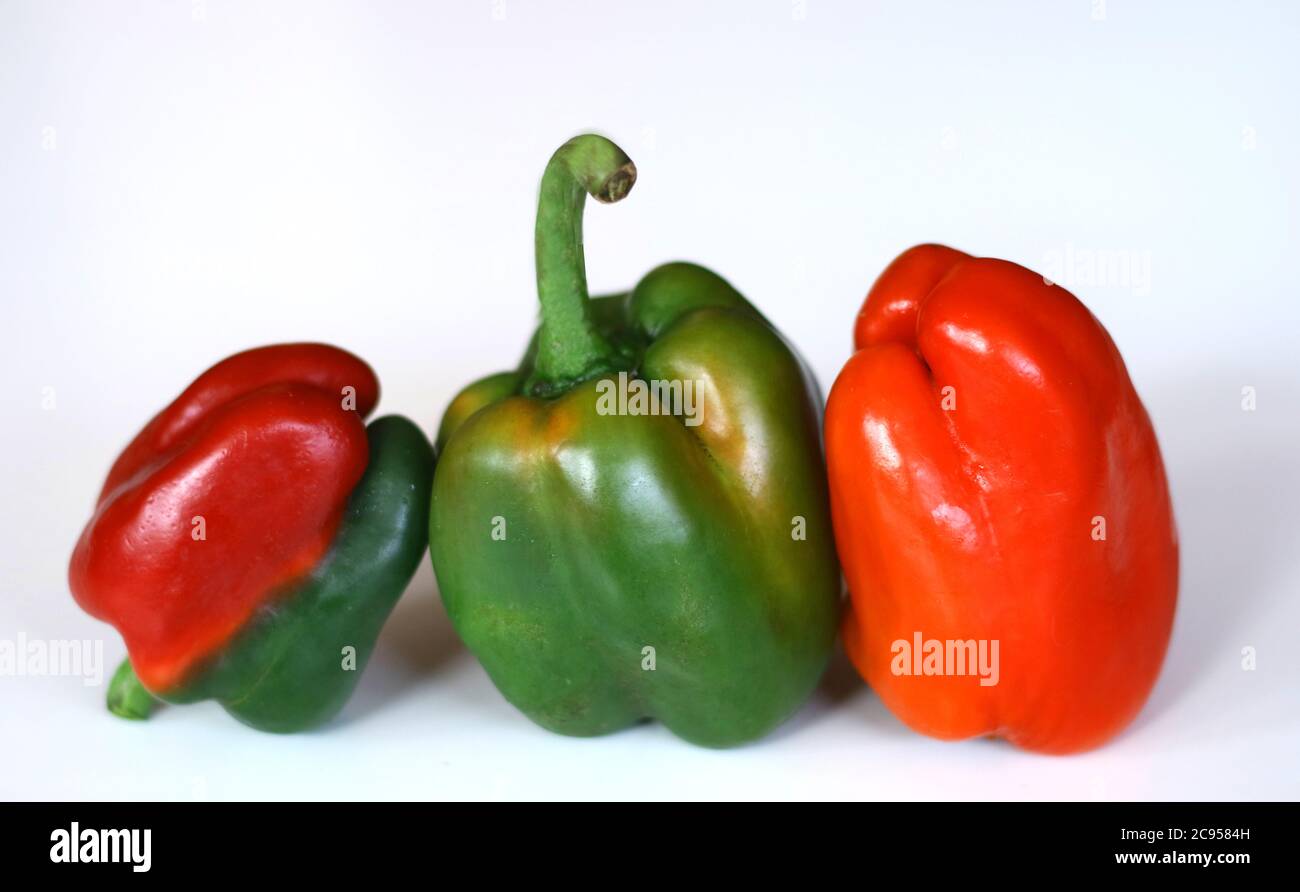 Red and green paprika on white background. Stock Photo
