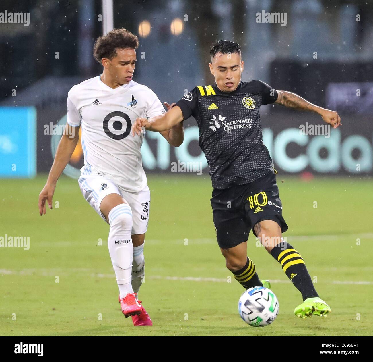 Orlando, Florida, USA. July 28, 2020: Columbus Crew midfielder LUCAS ZELARRAYAN (10) competes for the ball against Minnesota United midfielder HASSANI DOTSON (31) during the MLS is Back Tournament Columbus Crew SC vs Minnesota United FC match at ESPN Wide World of Sports Complex in Orlando, Fl on July 28, 2020. Credit: Cory Knowlton/ZUMA Wire/Alamy Live News Stock Photo