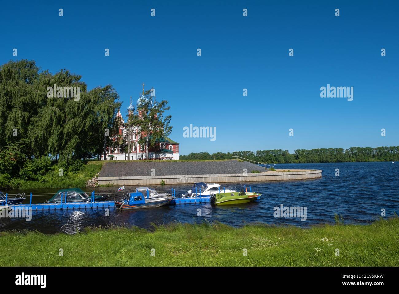 Berth with boats in Kamenny Brook and the Church of Demetrius on Blood on a sunny summer day. Stock Photo