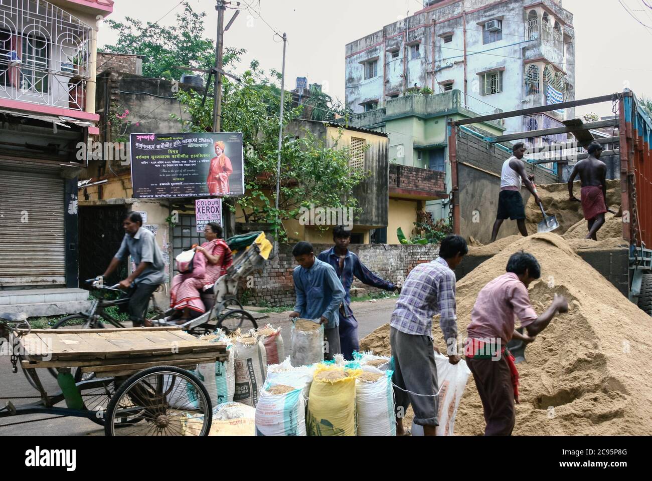 Kolkata, India - Aug 24, 2021 : young india labours working at the local construction site on the street in the city. people and lifestyle concepts. Stock Photo