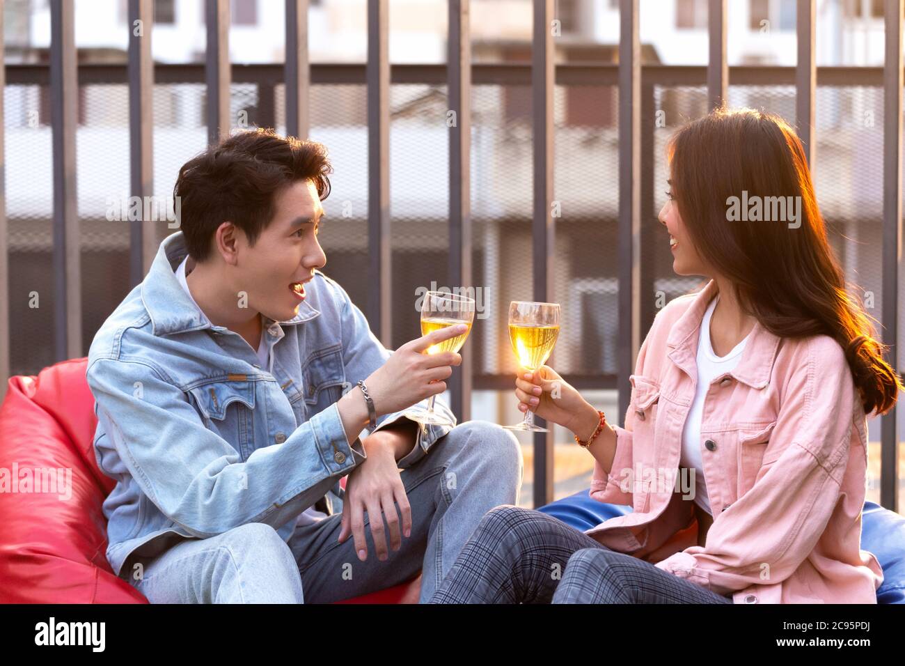 asian lover couple man and woman cheering and toast with white wine glasses to celebrating first dating in dinner party in the summertime. love, celeb Stock Photo