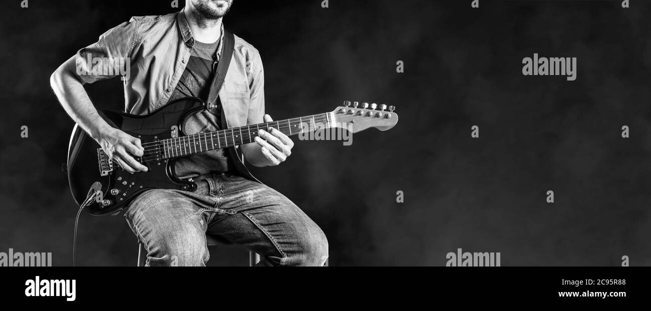 Jazz guitar player performing on electric guitar. Male guitarist