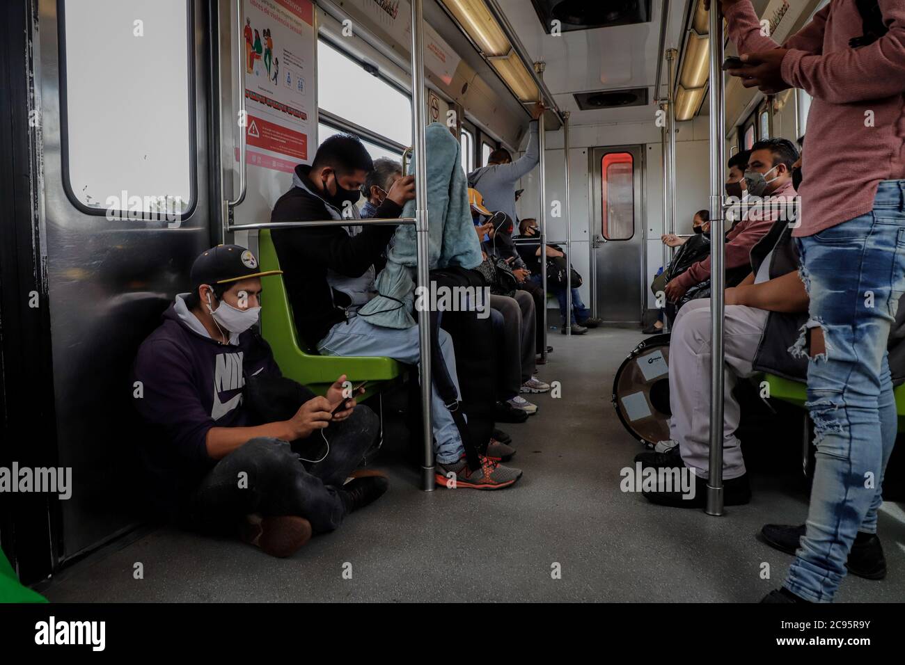 Mexico City, Mexico. 28th July, 2020. People are seen wearing masks on public transport in Mexico City, Mexico, July 28, 2020. Mexico registered 7,208 new COVID-19 cases, bringing the nationwide count to 402,697 cases, the health ministry said Tuesday. Credit: Str/Xinhua/Alamy Live News Stock Photo
