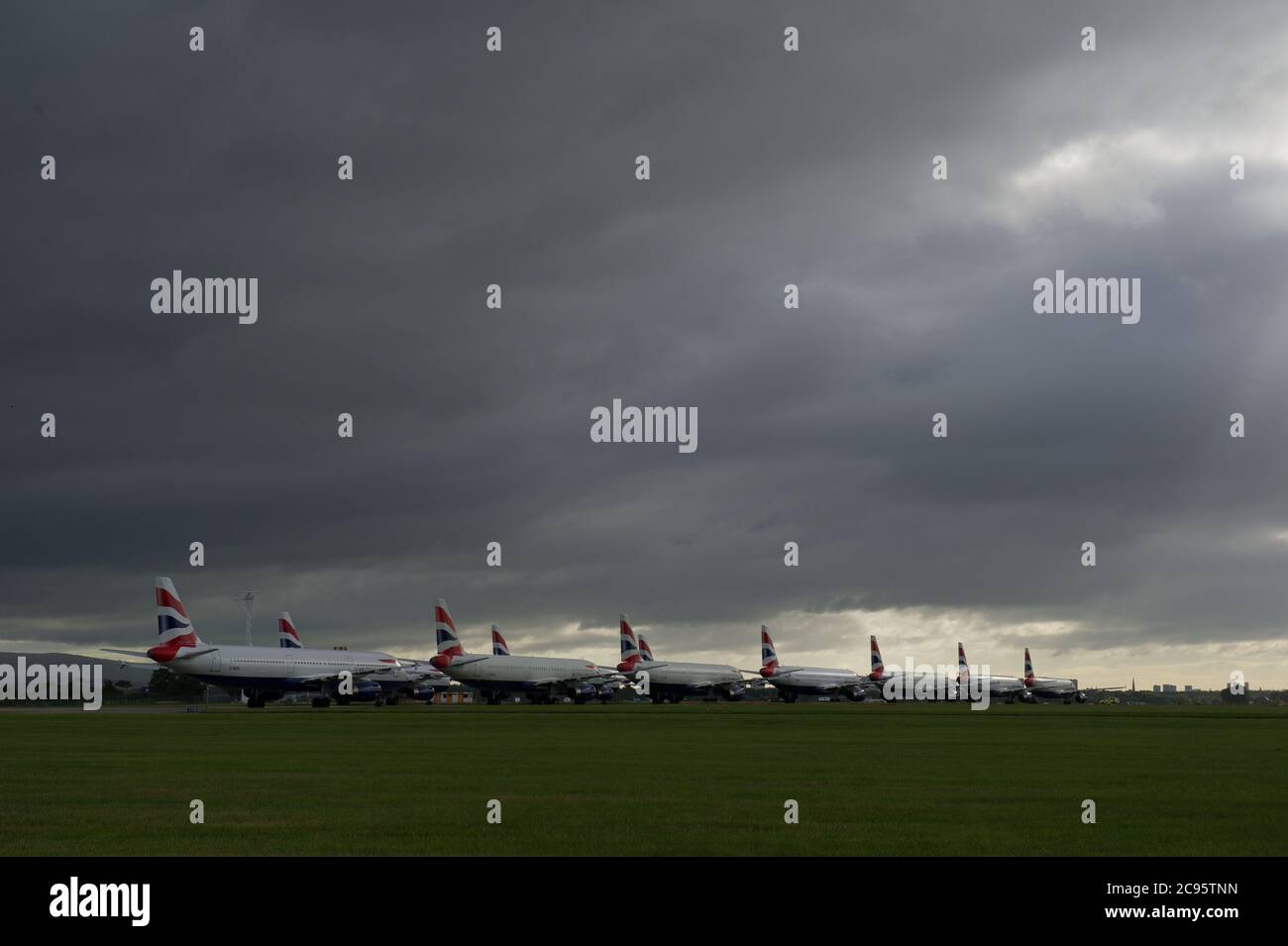 Glasgow, Scotland, UK. 29th July, 2020. Pictured: A collection of grounded British Airways Airbus A319/A320 & A321 aircraft stand idle on the tarmac at Glasgow Airport due to the ongoing coronavirus (COVID-19) pandemic which has affected the global aviation industry where BA have axed a quarter of their staff in a bid to cut spiralling costs to save the airline from going under against huge financial pressures. Credit: Colin Fisher/Alamy Live News Stock Photo