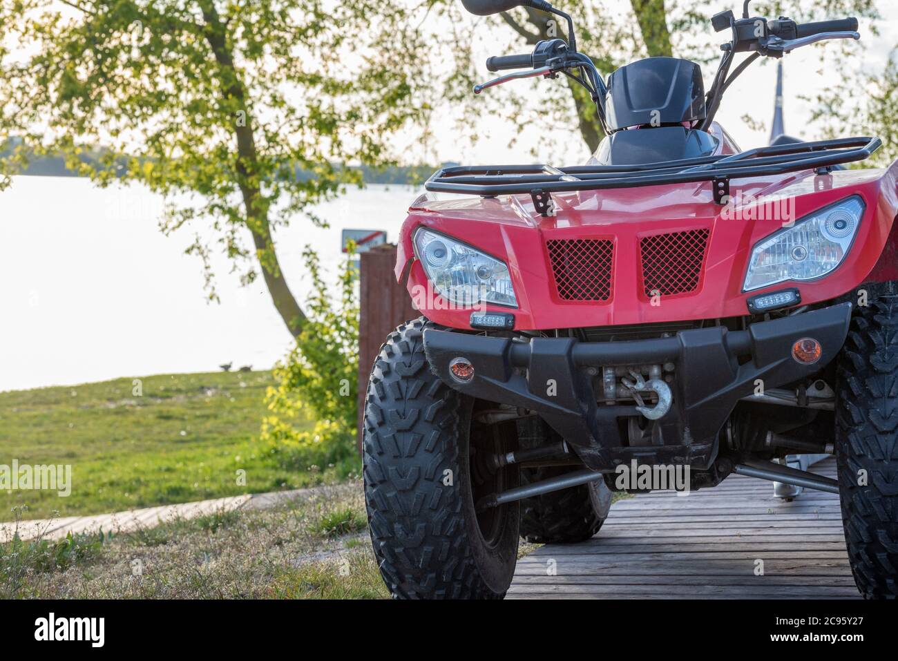 ATV, all terrain vehicle, red quad bike parked in countryside for off road adventures and travelling Stock Photo