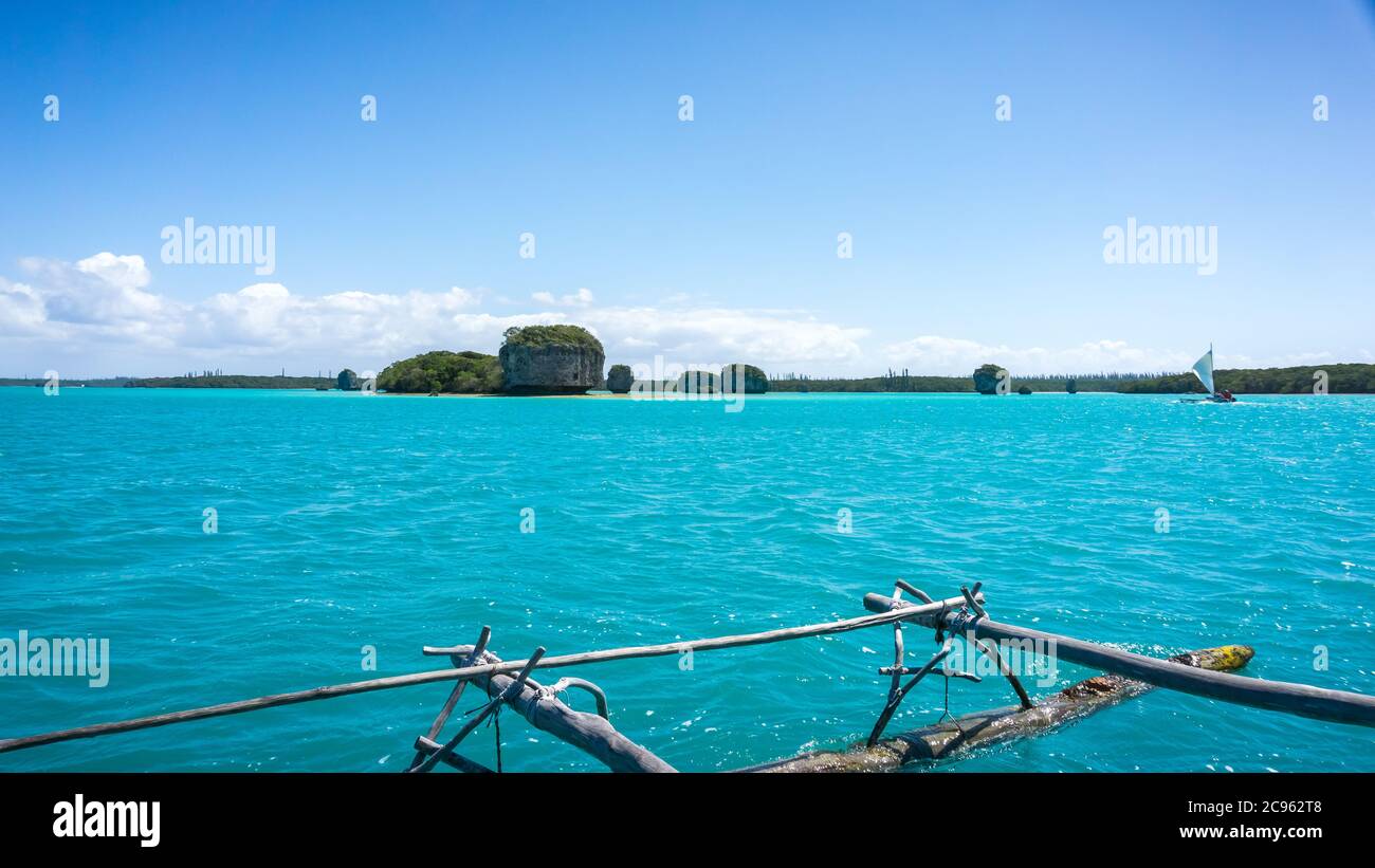 boat trip on a traditional caledonian sailing boat in Upi bay. typical rocks in the turquoise sea. seascape of Pines Island, new caledonia: turquoise Stock Photo