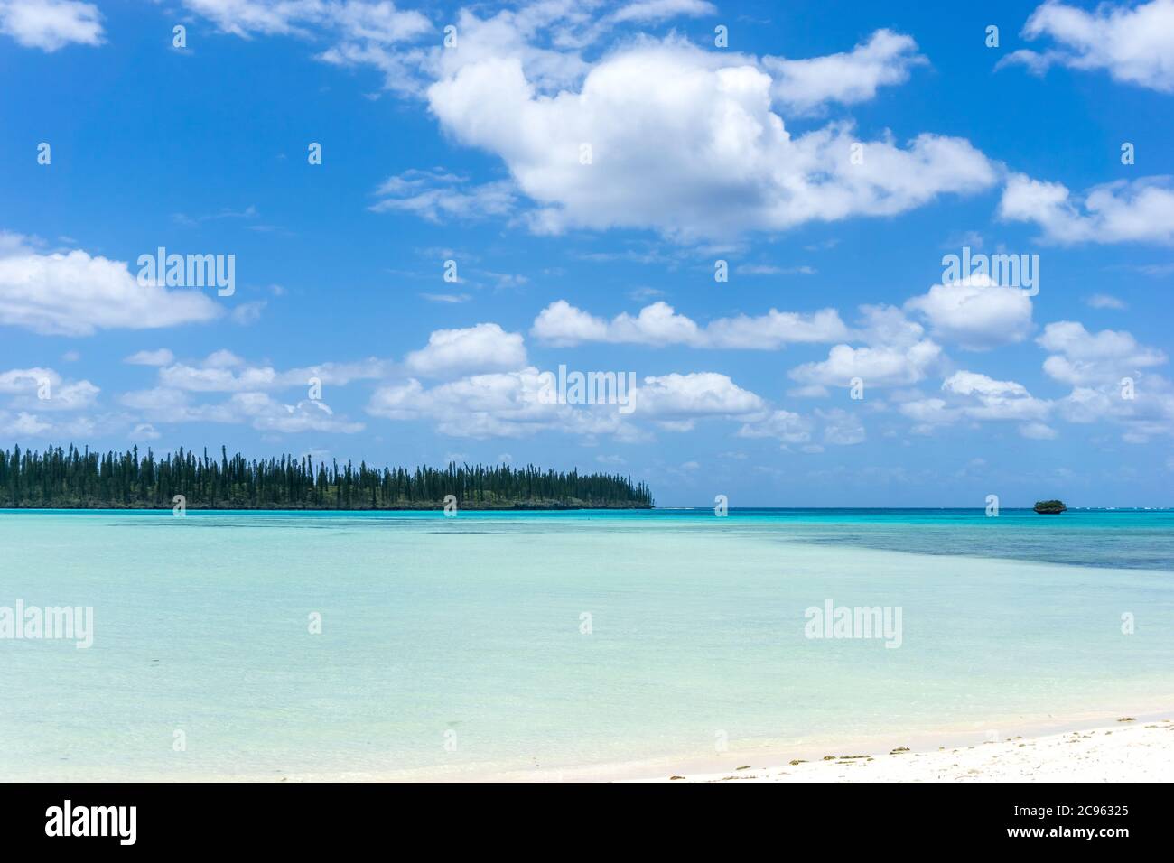 seascape of Pines Island, new caledonia: turquoise lagoon, typical rocks, blue sky Stock Photo