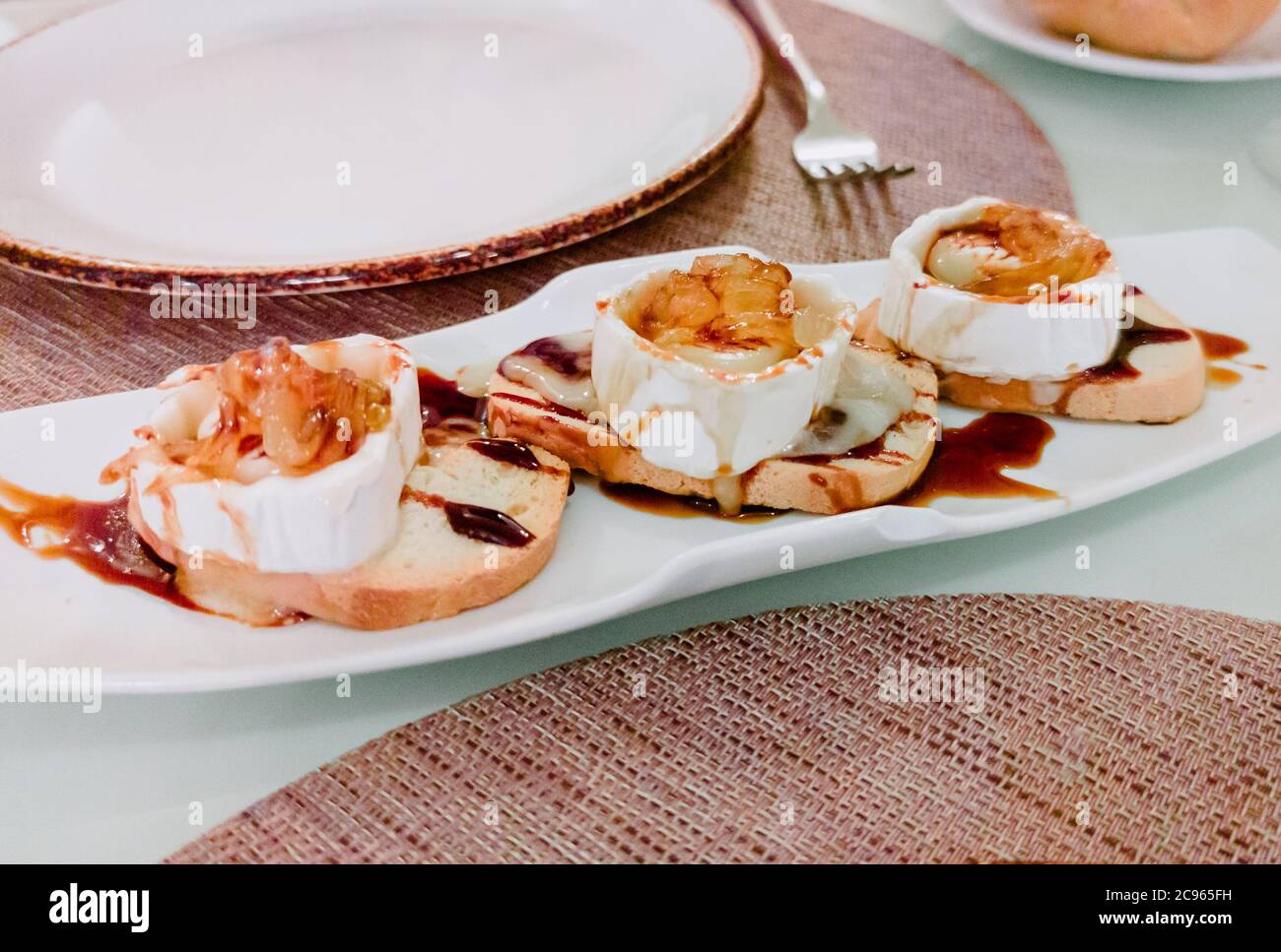 delicious pieces of goat cheeses with caramelized onions Stock Photo