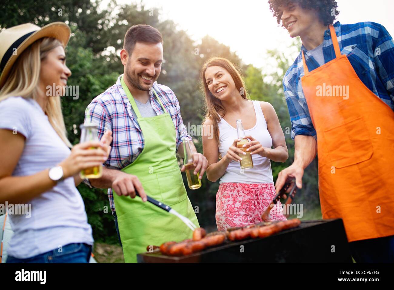 Small group of friends having fun at barbecue party Stock Photo Alamy