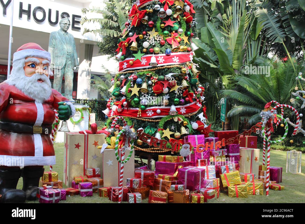 Kolkata, West Bengal/India - December 29, 2019: Cropped View of Santa Claus and Christmas tree and colorful gift boxes in low light for Christmas deco Stock Photo