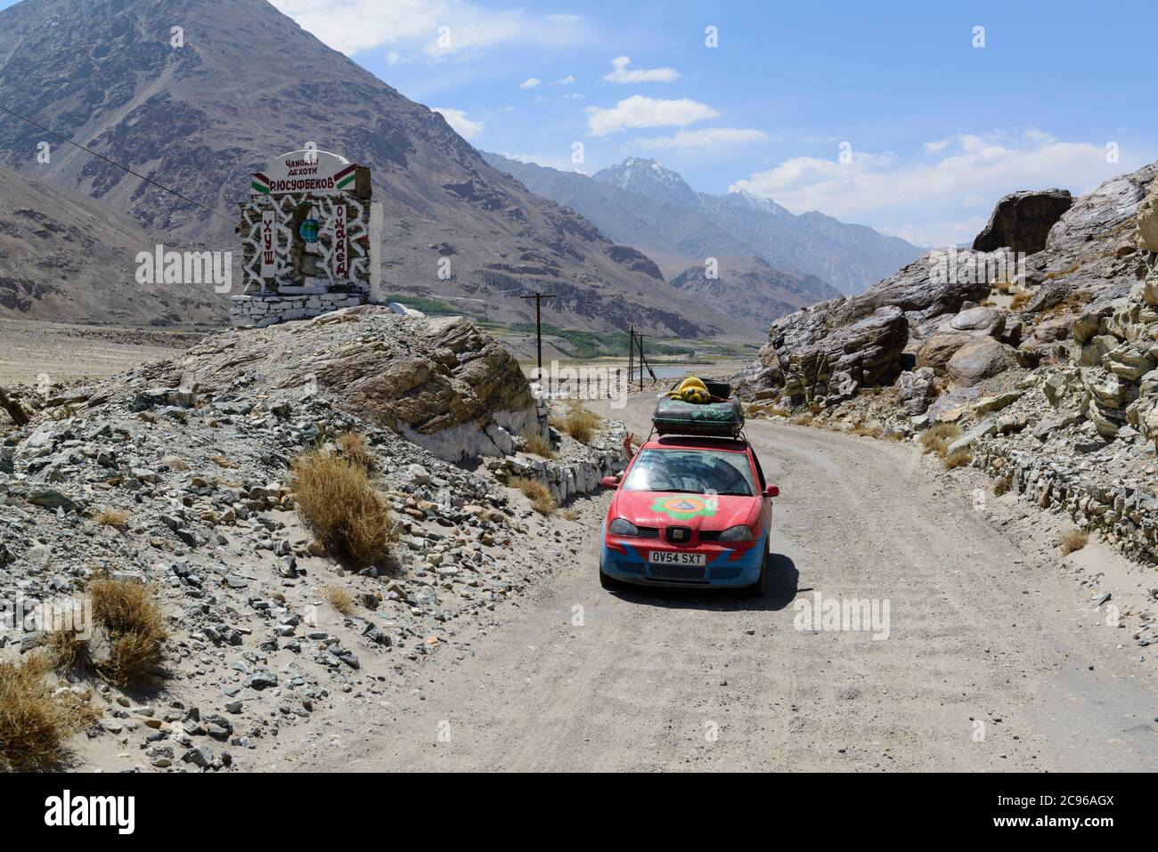 A Mongol Rally car on the bumpy road along the Wakhan Corridor, Tajikistan, Stock Photo