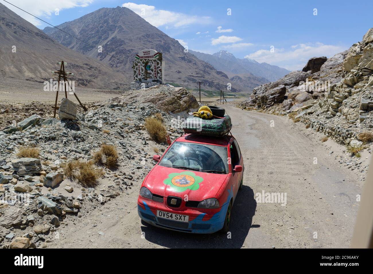 A Mongol Rally car on the bumpy road along the Wakhan Corridor, Tajikistan, Stock Photo