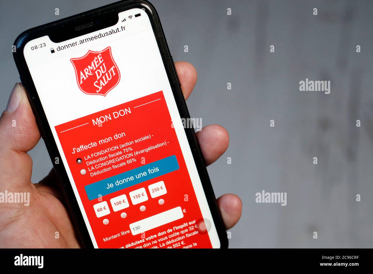 Online funding on  smartphone to support Salvation Army.  France. Stock Photo