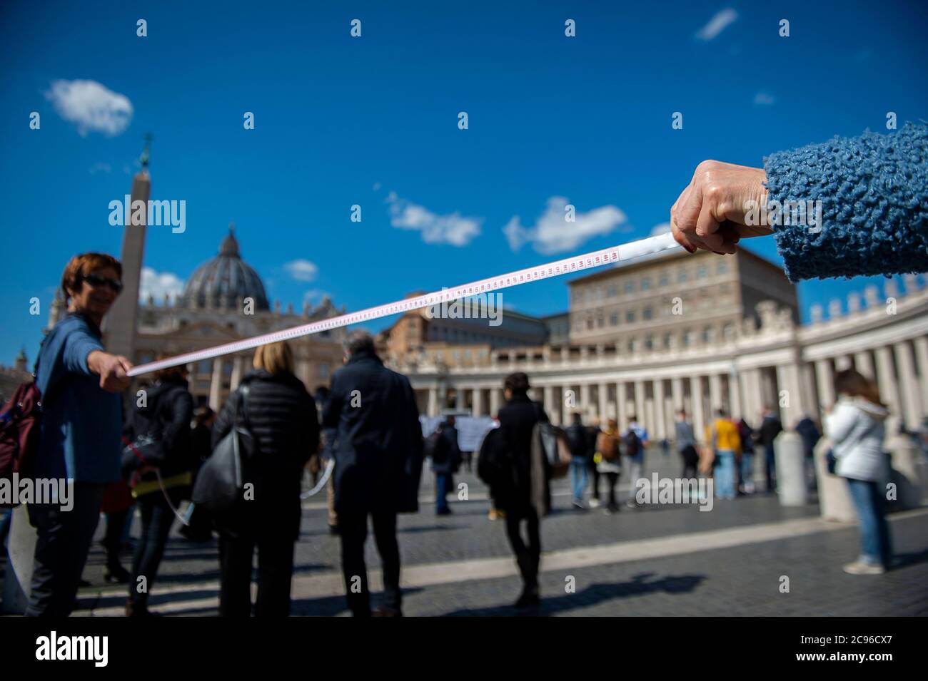 Measuring safety distance between people during the live-broadcast of Sunday Angelus prayer at Saint Peter's square at the Vatican. Millions of people Stock Photo