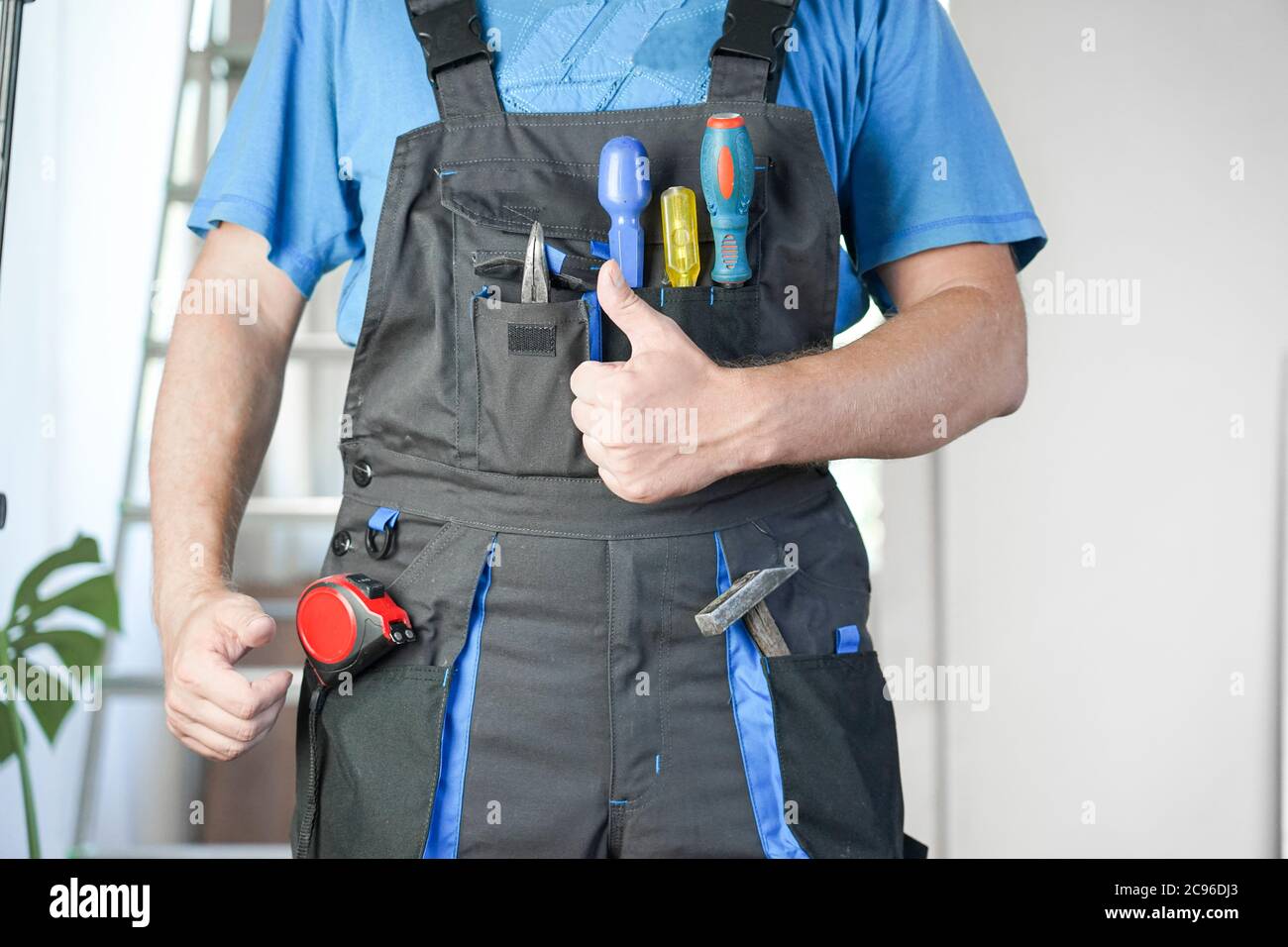 Guy in work clothes shows like Stock Photo