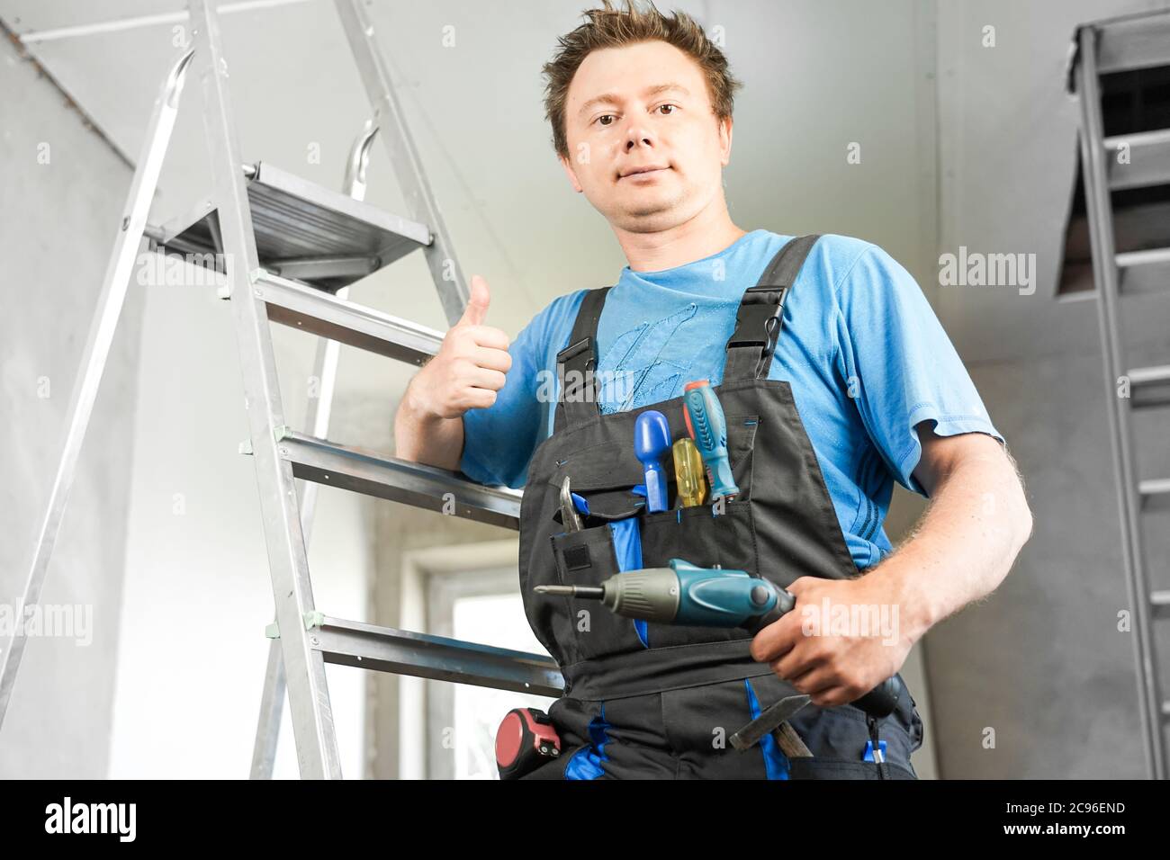 Guy in work clothes shows like Stock Photo