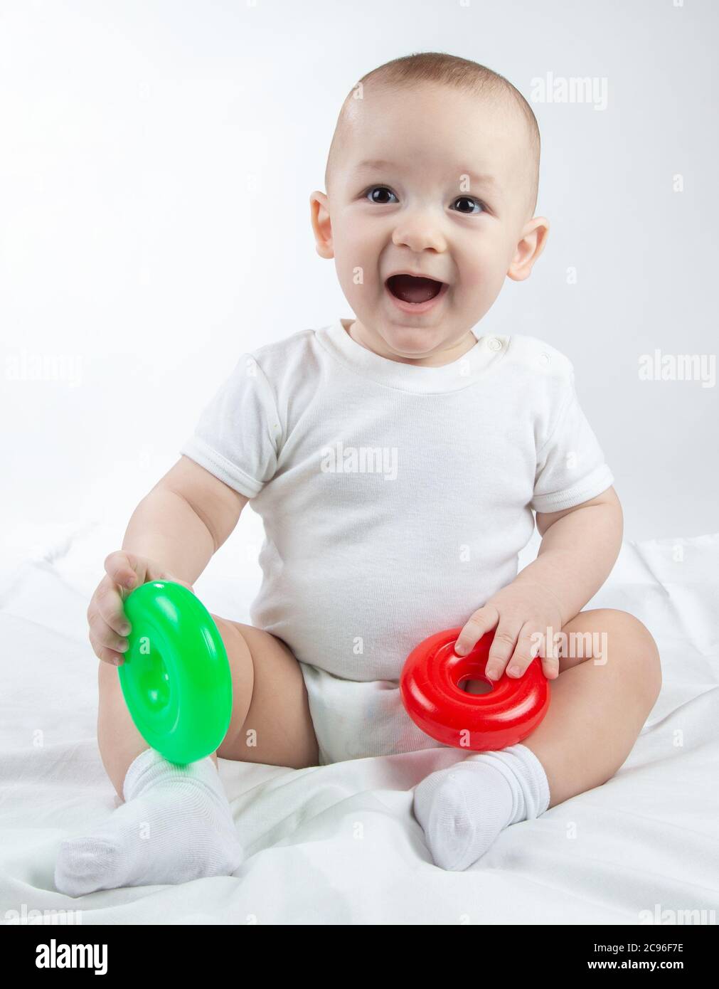 Photo of a ninemonthold baby with bright toys Stock Photo Alamy