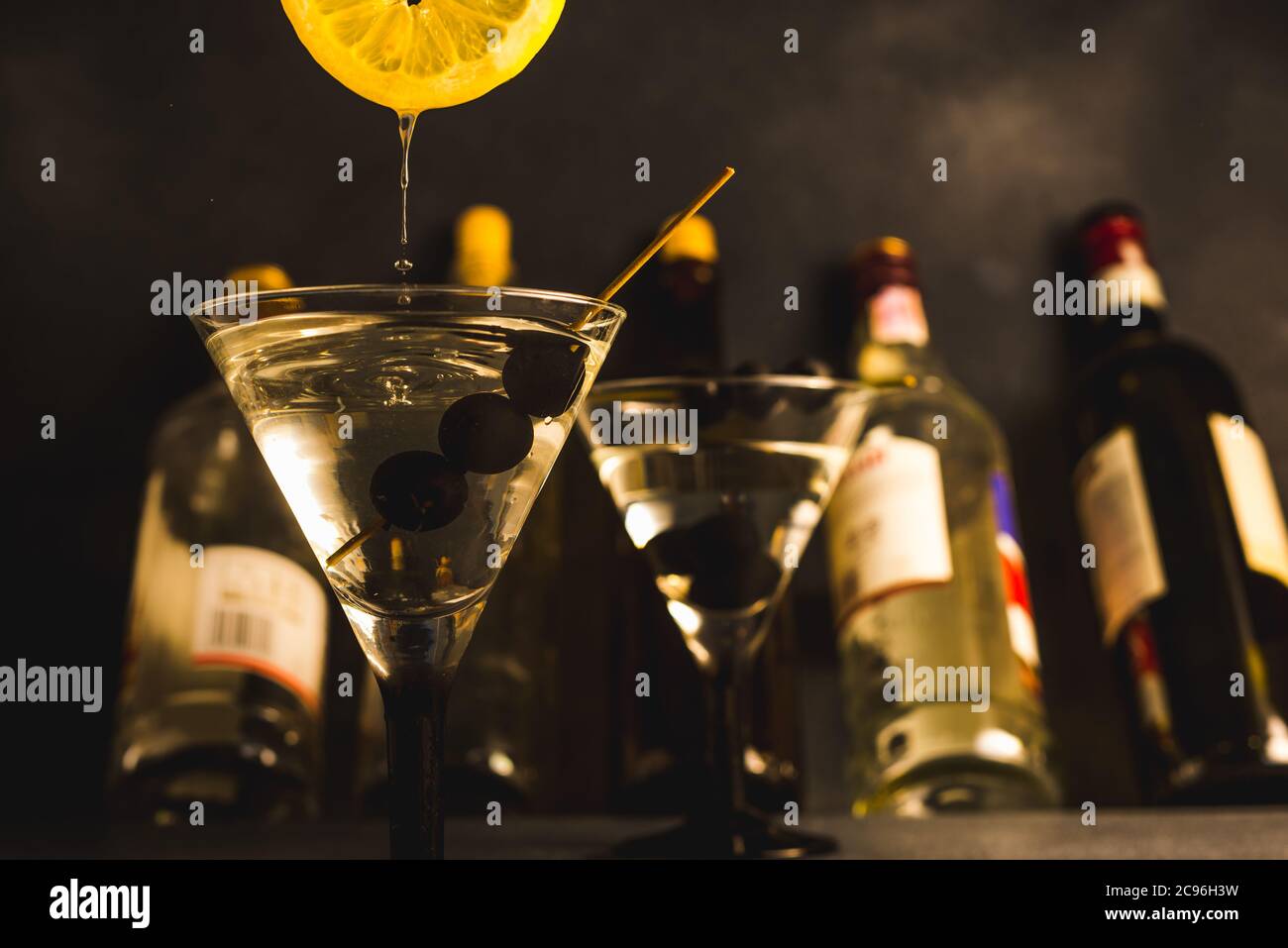 Alcohol cocktail with splash.Dry martini with black olives.Vermouth