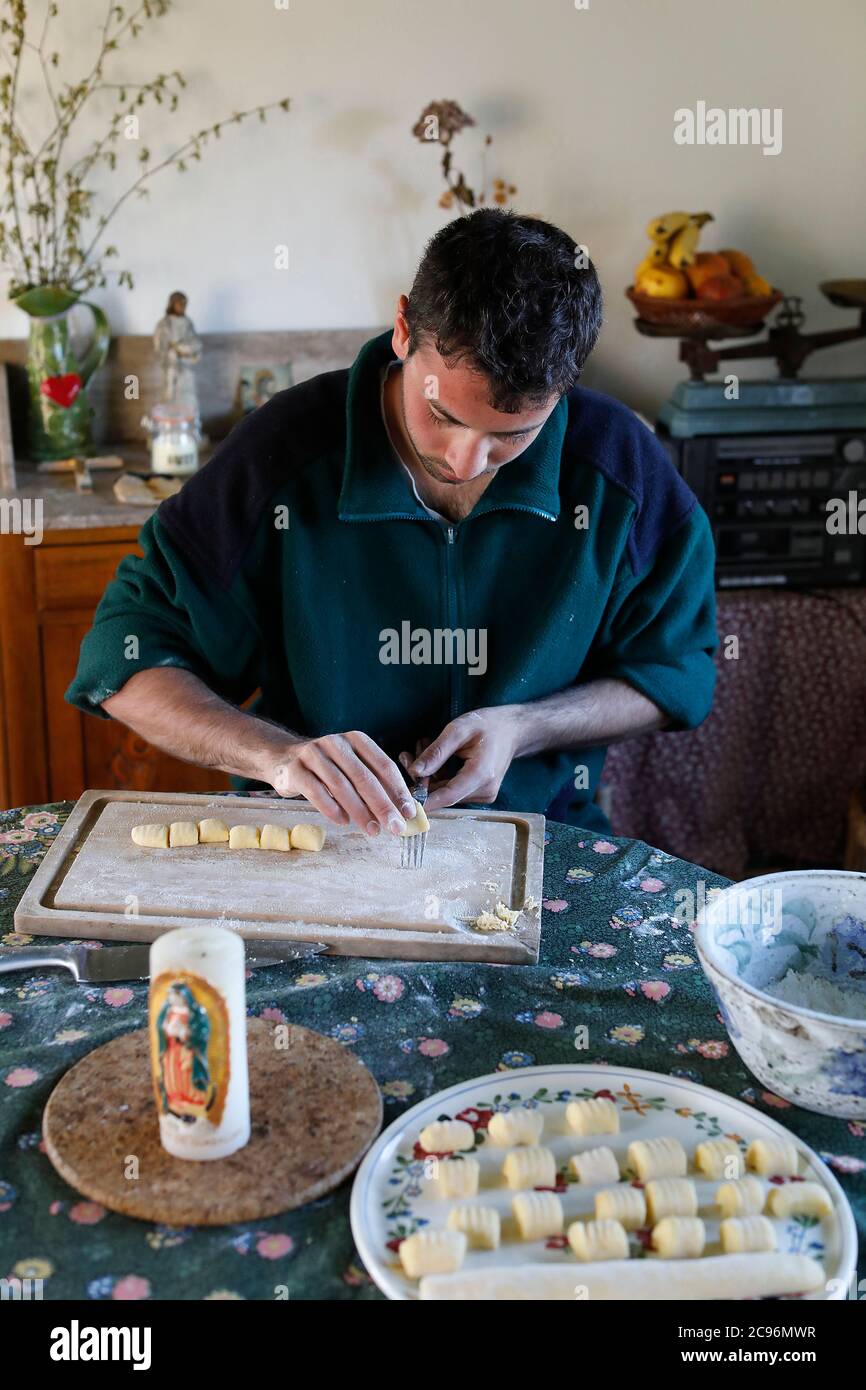 Young man making gnochi in Eure, France. Stock Photo