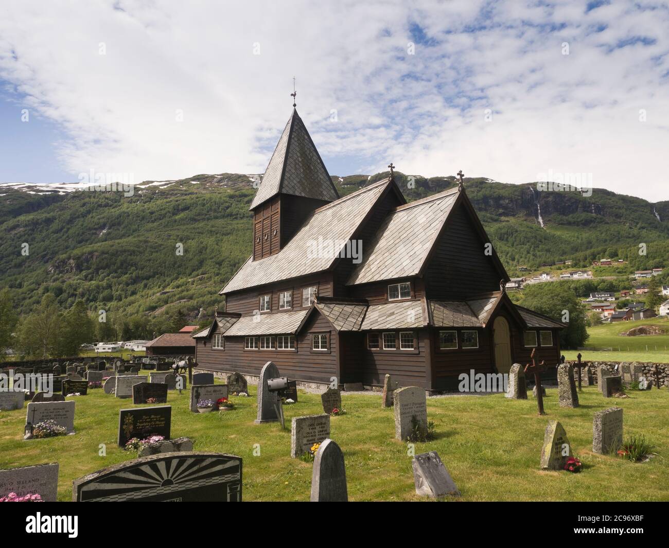 Røldal Stave Church dec in a valley in western Norway dating back to ca 1250, exterior with cemetery ant beautiful landscape Stock Photo