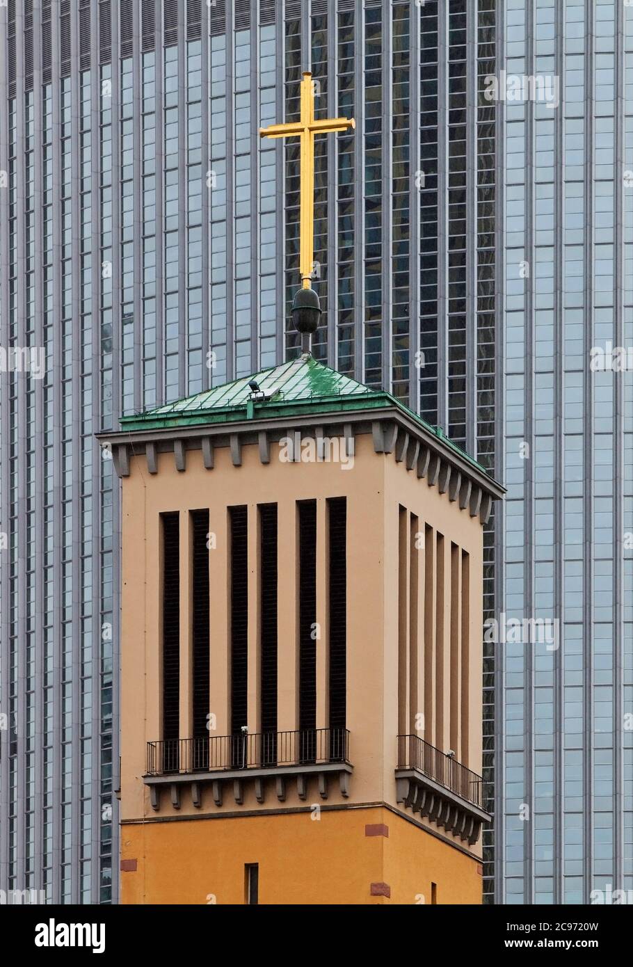 steeple of the Matthew Church in front of the modern aluminium facade of the Pollux high-rise office building, Germany, Hesse, Frankfurt am Main Stock Photo