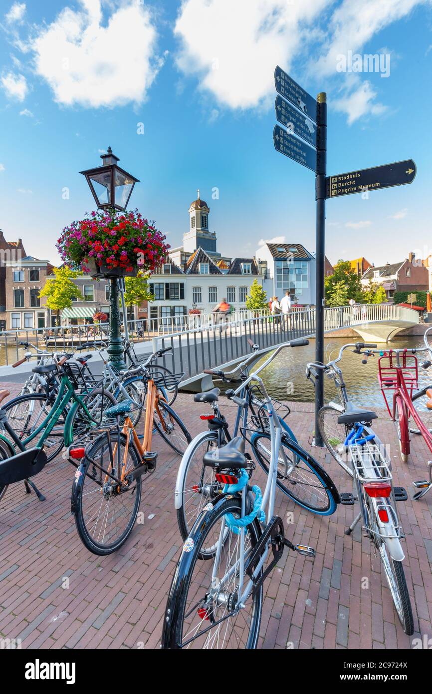 Leiden, Netherlands - July 21, 2020: Cityscape Leiden with Catharinabridge, waterways, bicyles and Hartebrug church during the summer. Stock Photo