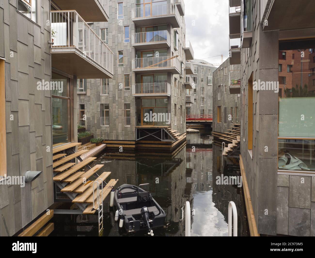 A new layer of buildings is being added in Bjorvika Oslo Norway directly on the fjord, business and apartment blocks combined, detail from canals Stock Photo