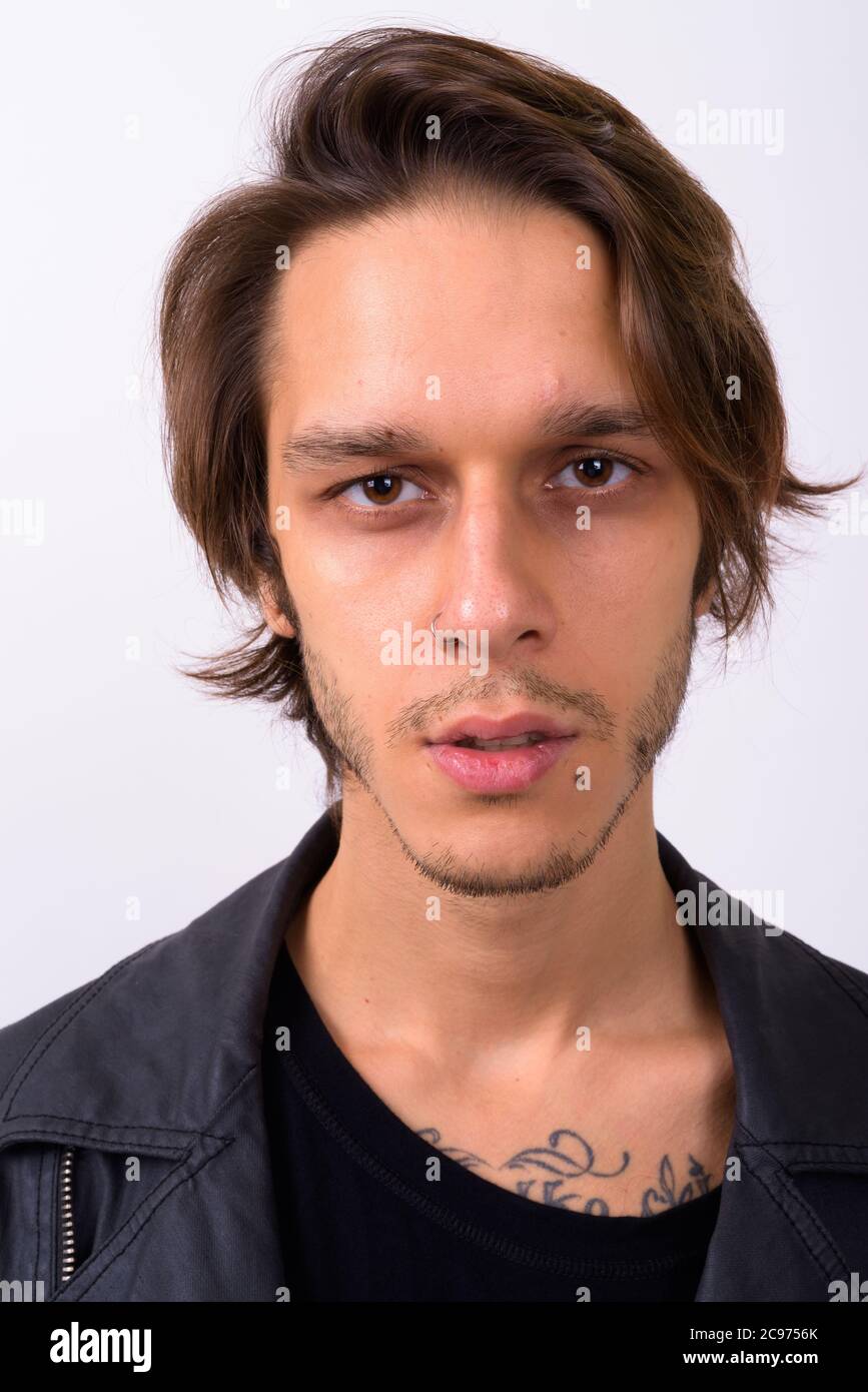 Young handsome rebellious man against white background Stock Photo Alamy