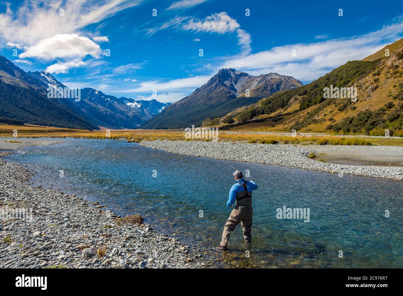 A fly fisherman casting on a beautiful mountain stream in New Zealand's  South Island, Ahuriri River, Omarama Stock Photo - Alamy