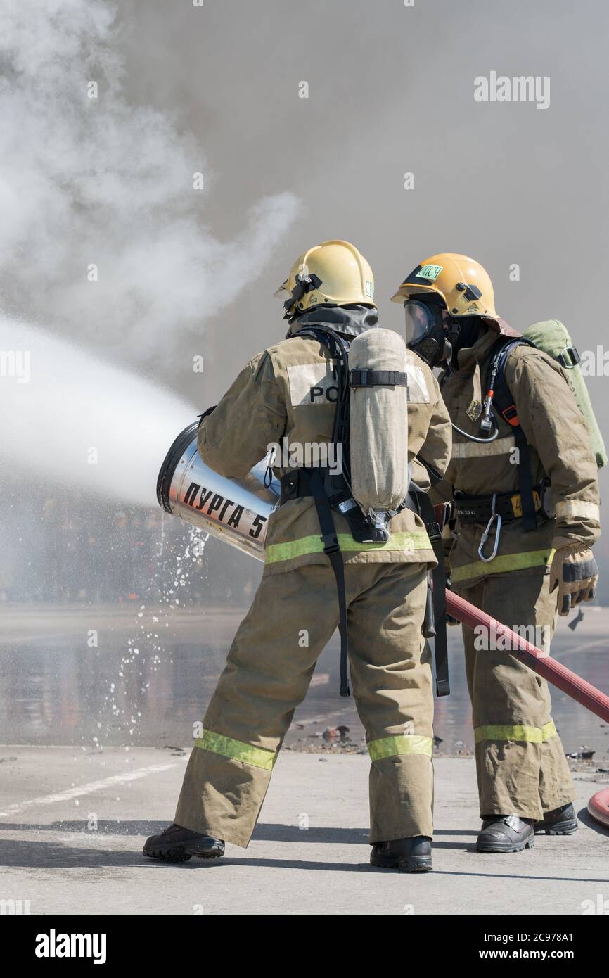 Firefighters extinguishes fire from fire hose, using firefighting water ...
