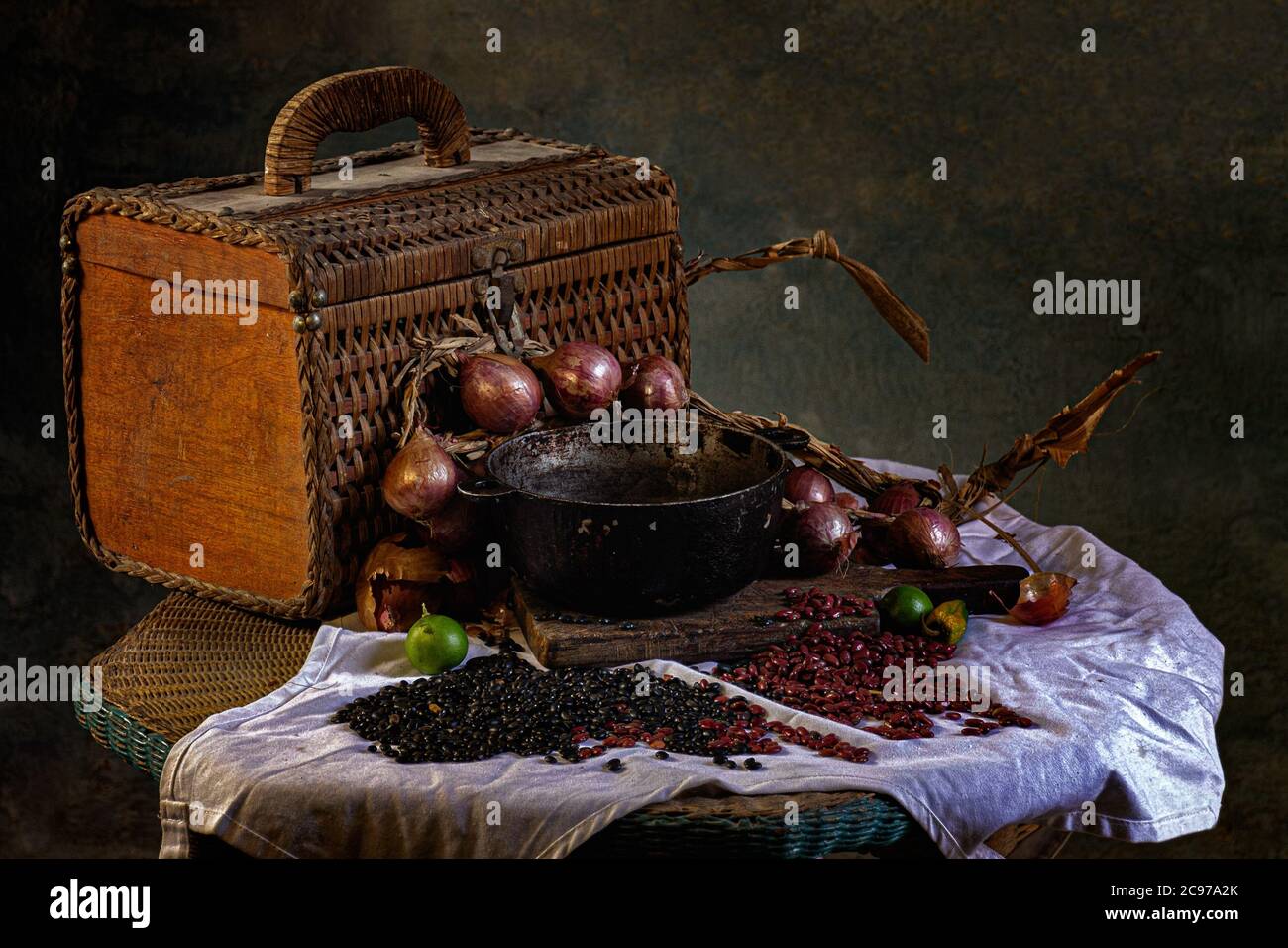 Rattan picnic basket with a small cauldron red onions and red and black