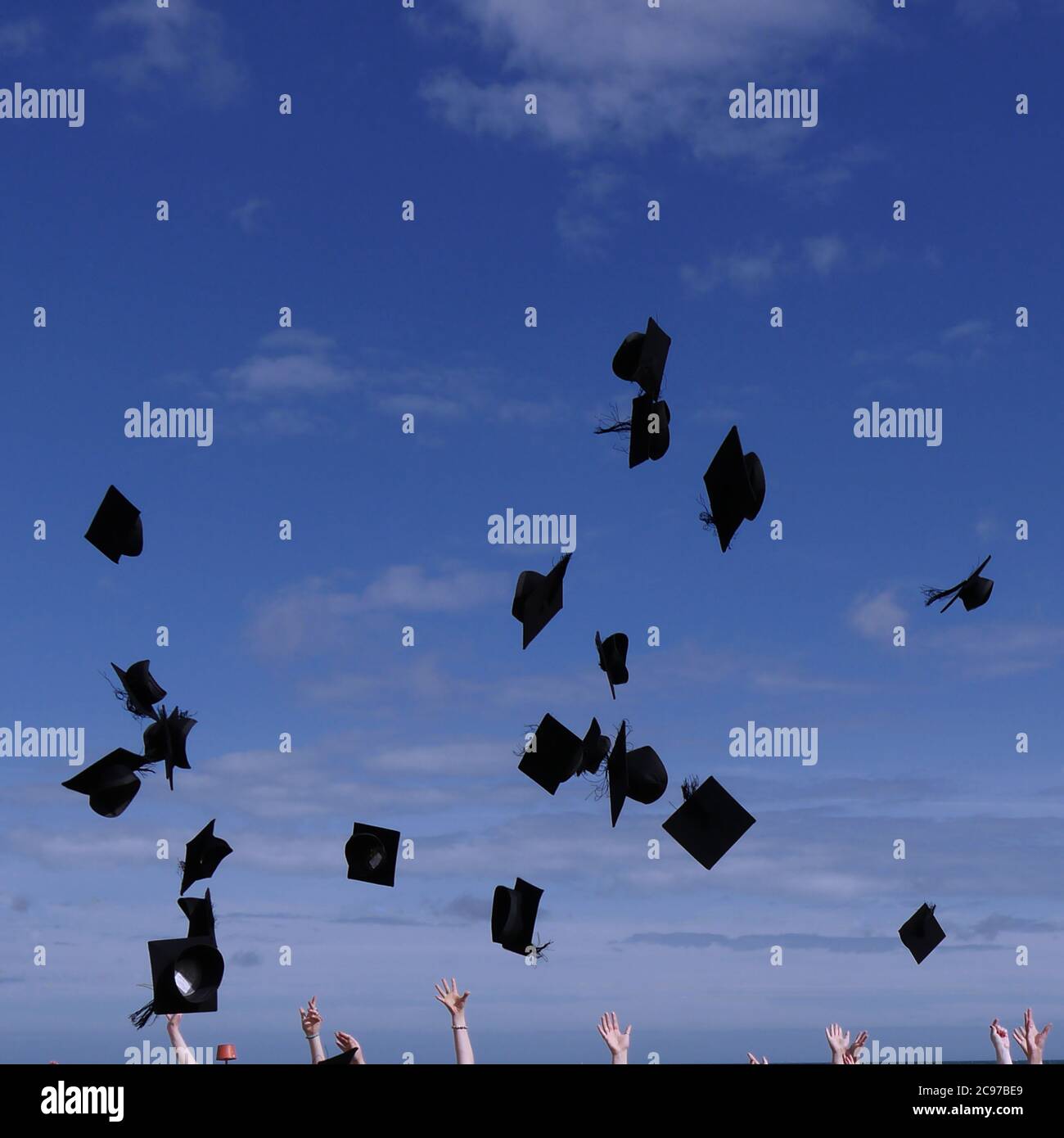 Beautiful shot of graduates throwing their graduation caps in the air Stock Photo Alamy