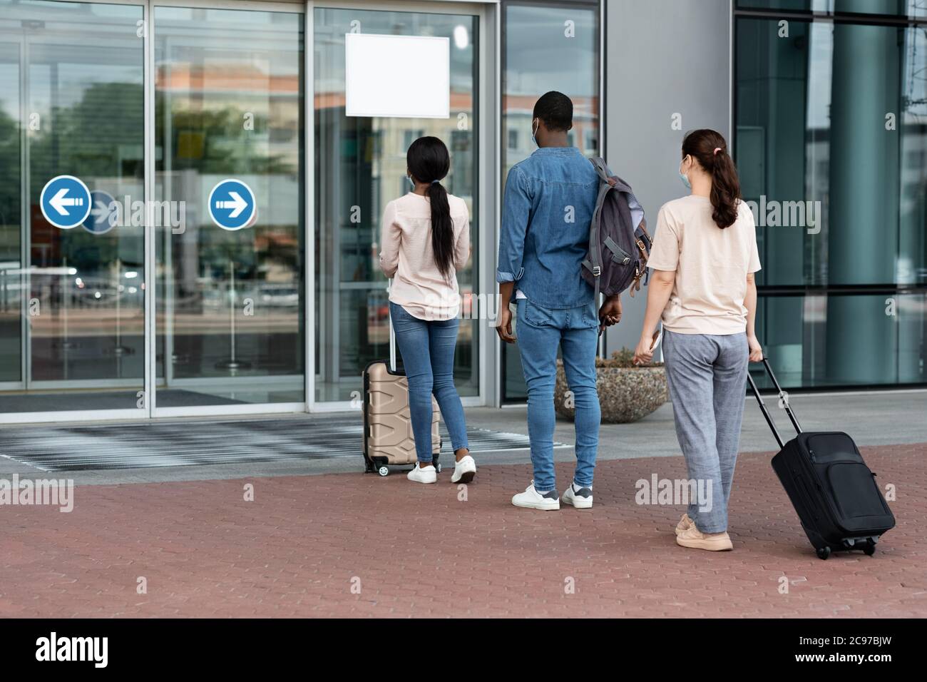 Airport Passengers Standing In Queue To Terminal Entrance With Social Distancing Rules Stock Photo