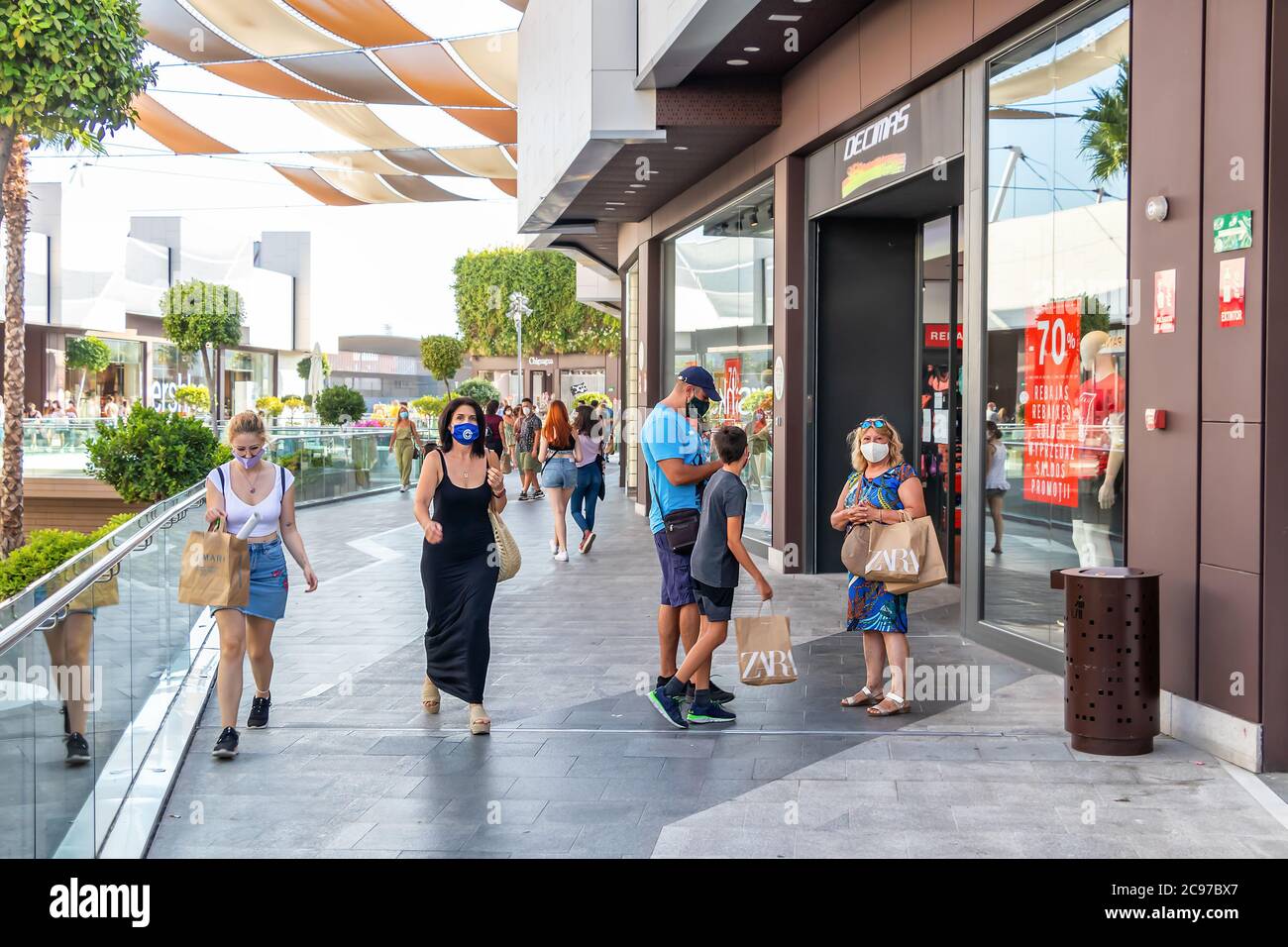 Huelva, Spain - July 27, 2020: People Shopping in Holea mall, wearing protective or medical face masks due to Covid-19 coronavirus. New normal in Spai Stock Photo