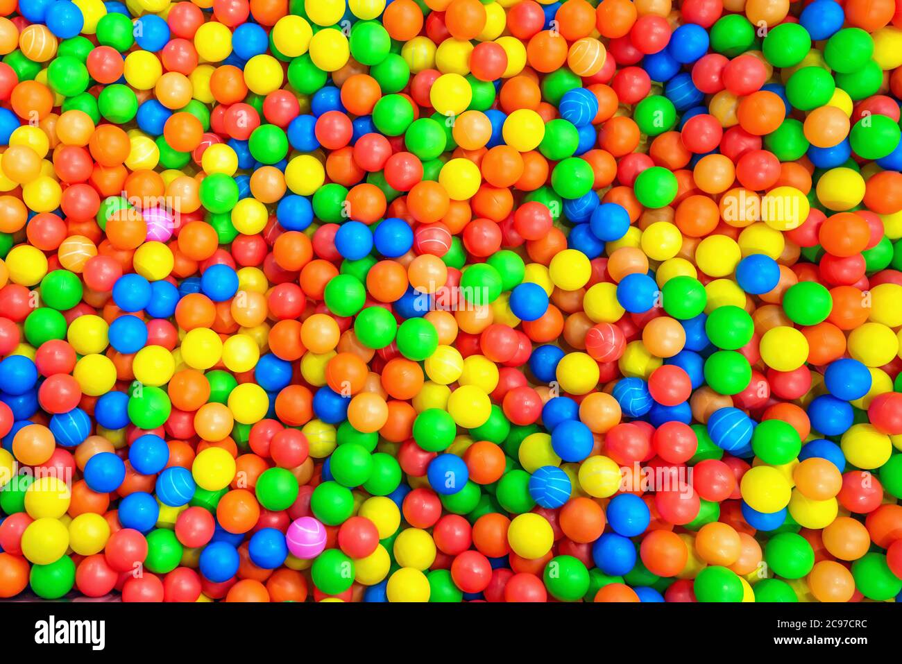 Multicolored balls in a children's attraction. Background texture of colourful foam balls Stock