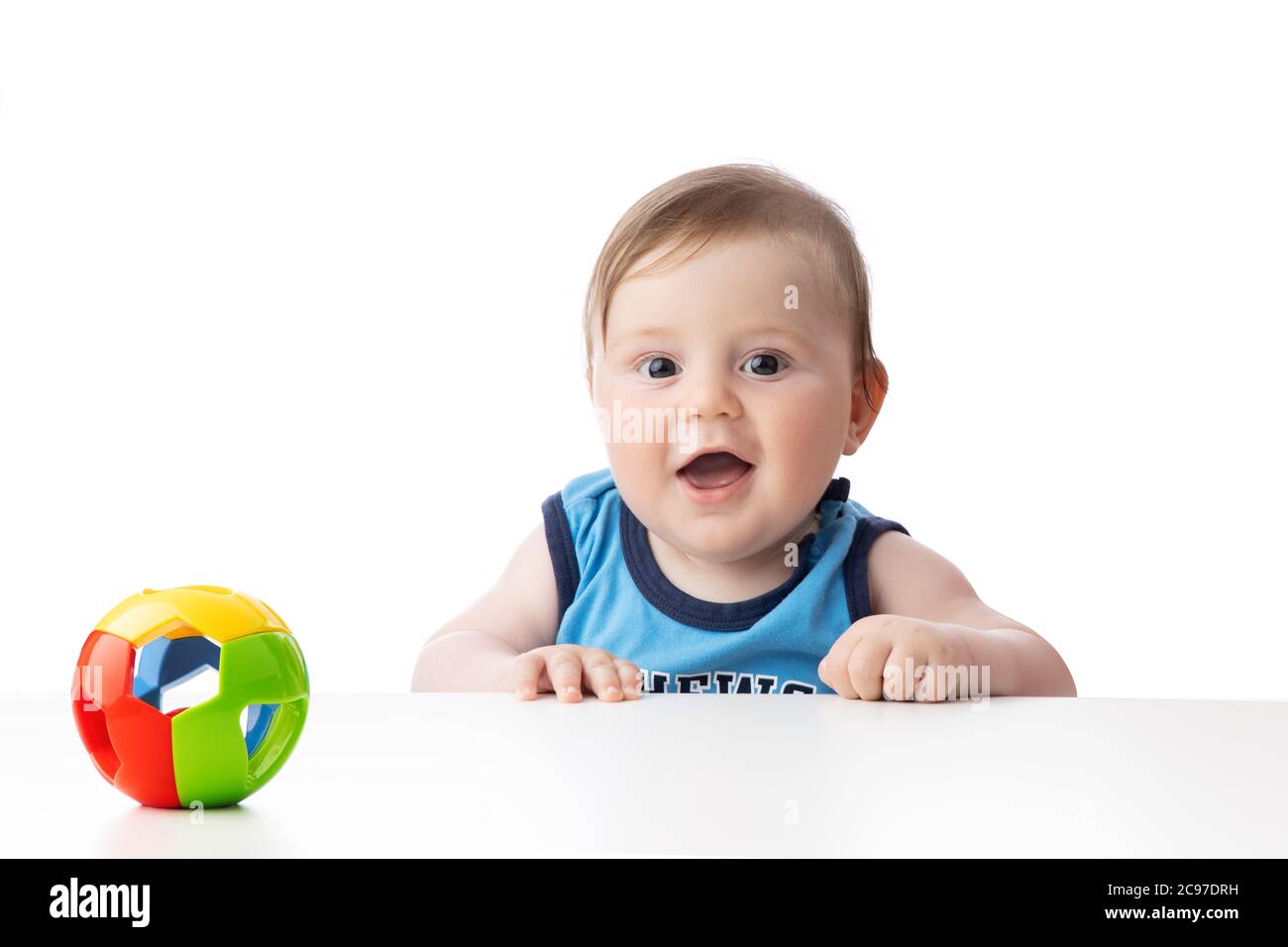 Cute baby boy looking surprised. 5 months baby ready to play games with toys. Stock Photo