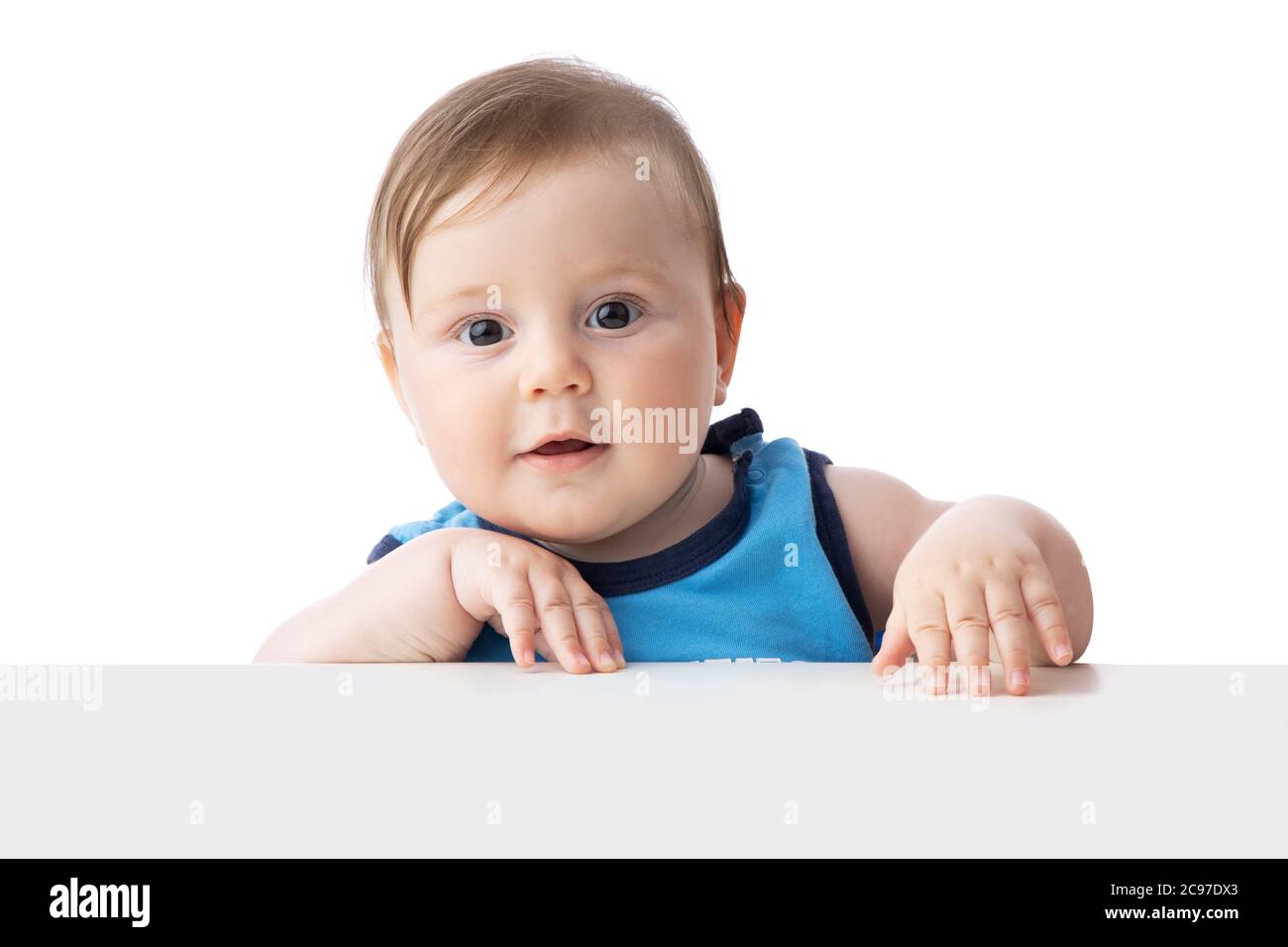 Cute baby boy looking surprised. 5 months baby ready to play games with toys. Stock Photo