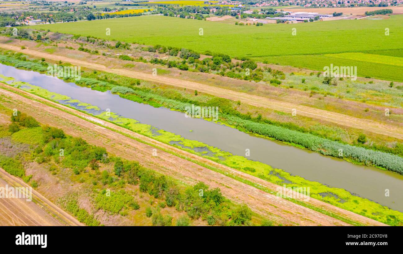Above view on part of river, canal who is going between agricultural ...