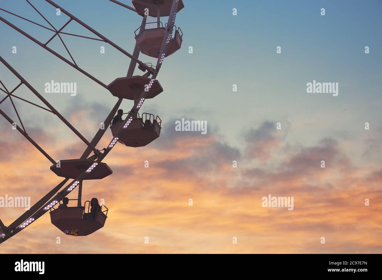 Ferris Wheel with sunset sky and clouds Stock Photo - Alamy