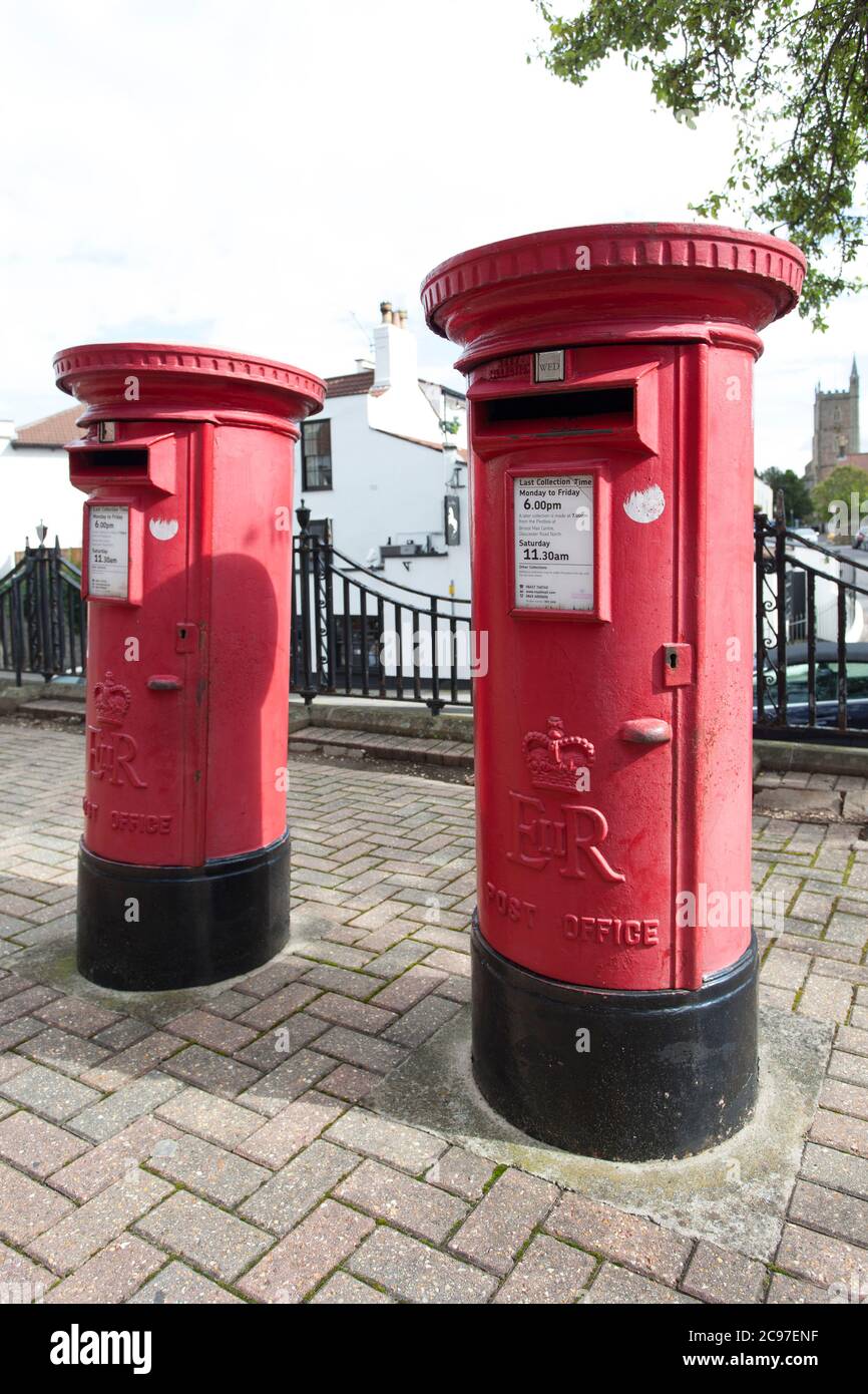 Two red post boxes standing side by side on a street in the UK. Stock Photo