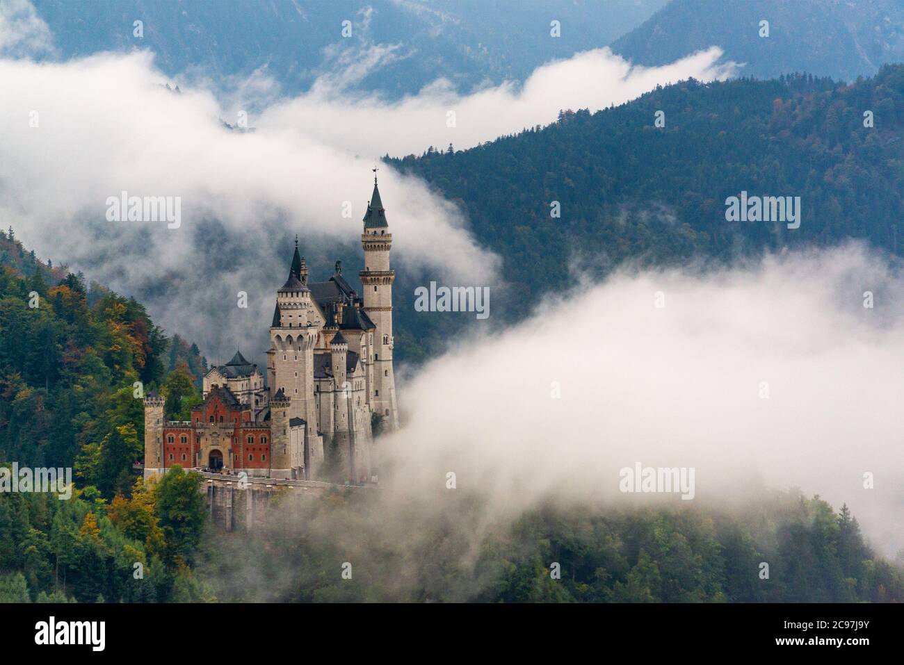 Neuschwanstein Castle with fog in the Bavarian Alps of Germany Stock Photo