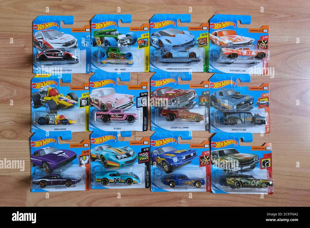 Istanbul, Turkey - July 29, 2020 : 12 Hot Wheels die cast toy cars in blisters on wooden floor from directly above view . Stock Photo