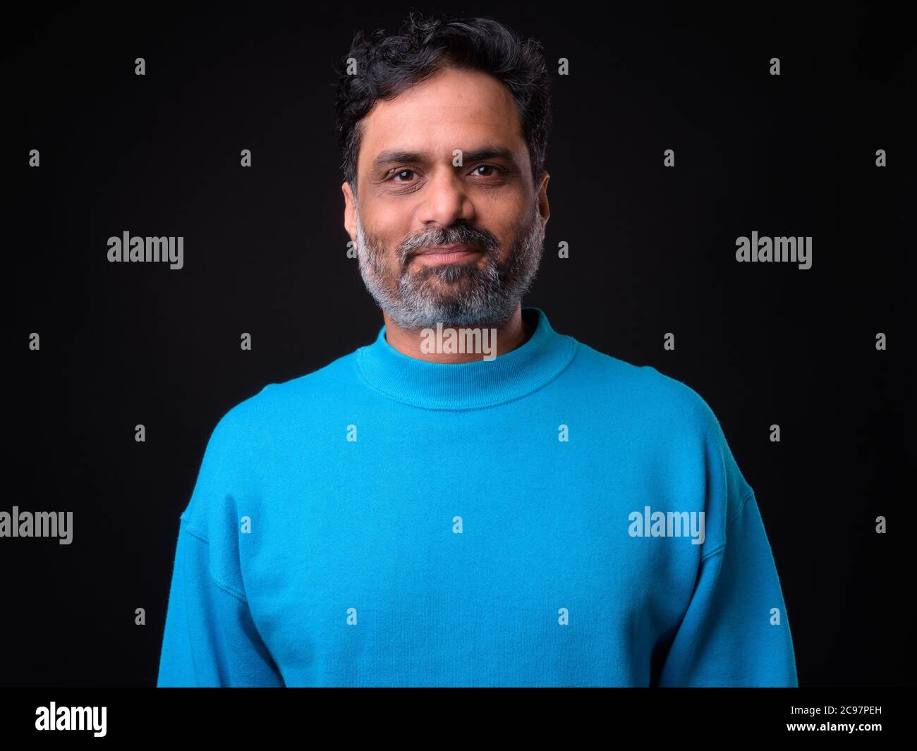 Portrait of mature bearded Indian man with curly hair Stock Photo - Alamy
