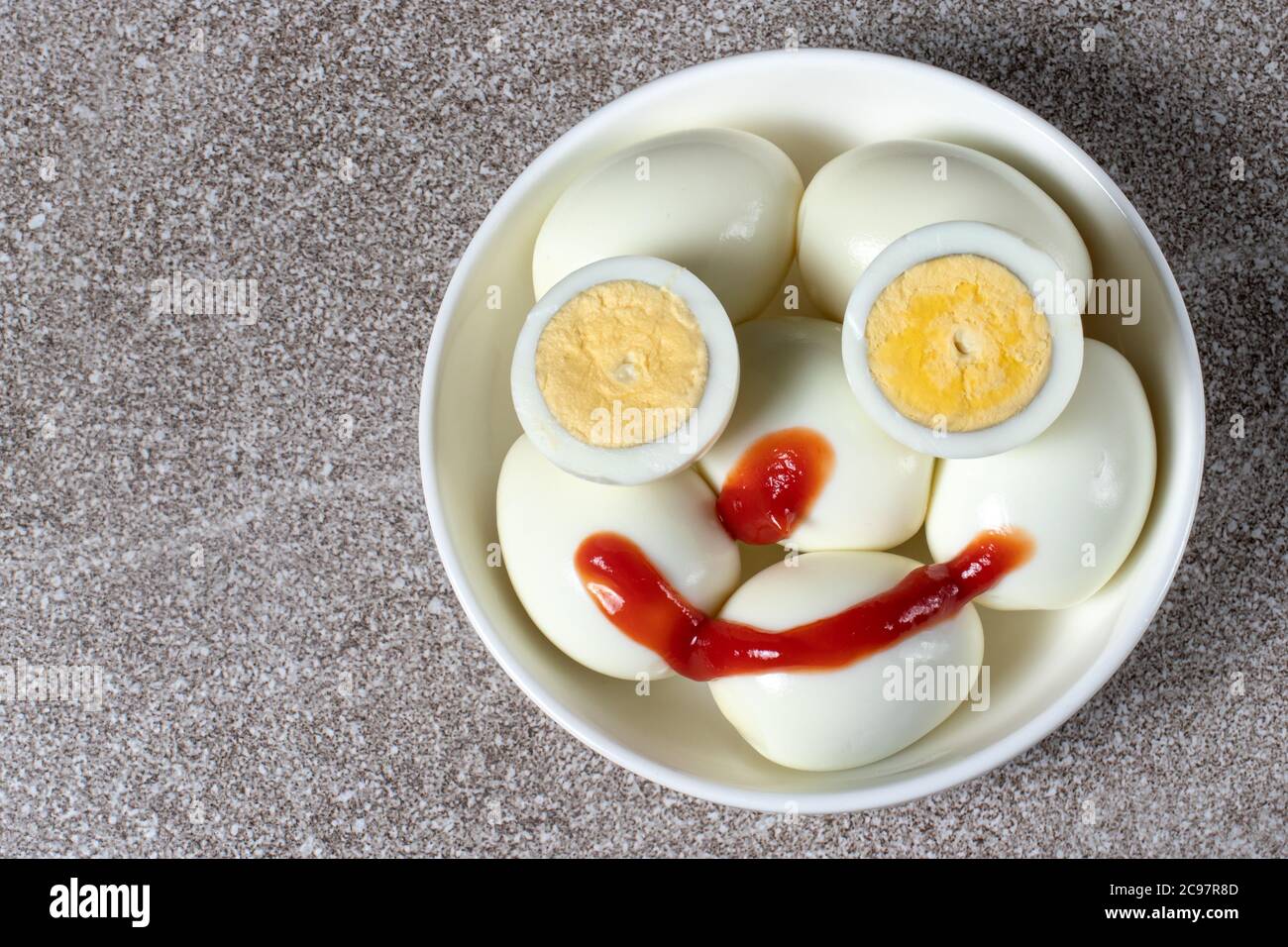 Merry fried eggs. Boiled eggs are smiling. Stock Photo