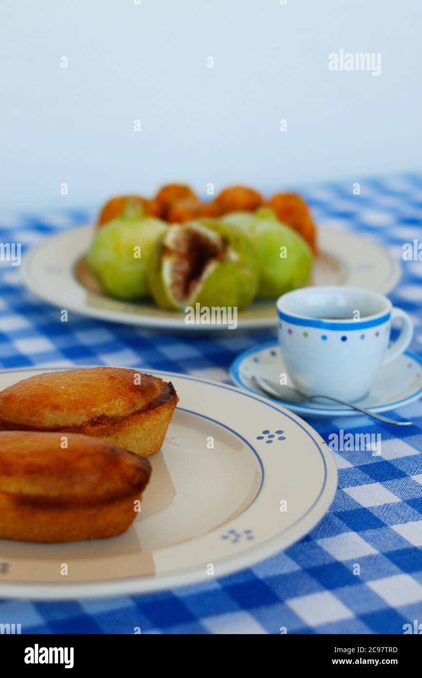 Breakfast in Salento, with typical products of the southern Italian tradition: Prickly pears, figs and Pasticciotto with cream on ceramic plates and w Stock Photo