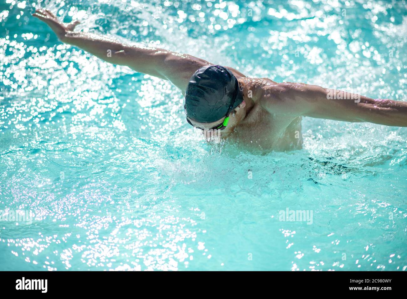 Man in swimming cap having a workout in pool Stock Photo